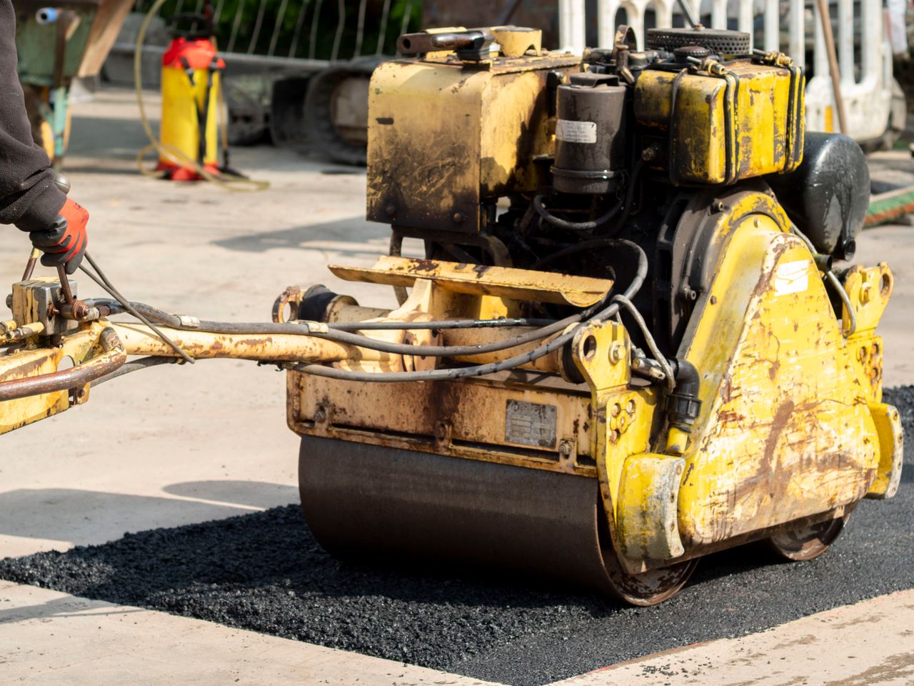 About Close-up of a road roller in action during asphalt repair in Wrocław, Poland.